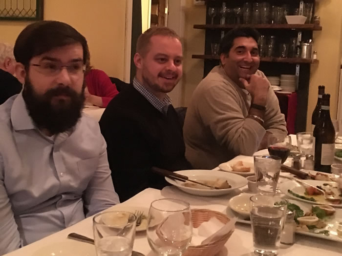 Krystian Charubin, David Hills, and Jayvin Arora at the Pennsylvania office holiday dinner