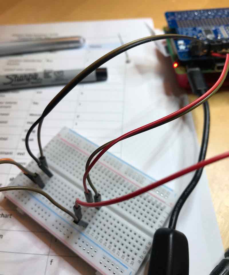 The Raspberry Piwith the MotorHat on and cables running to the breadboard