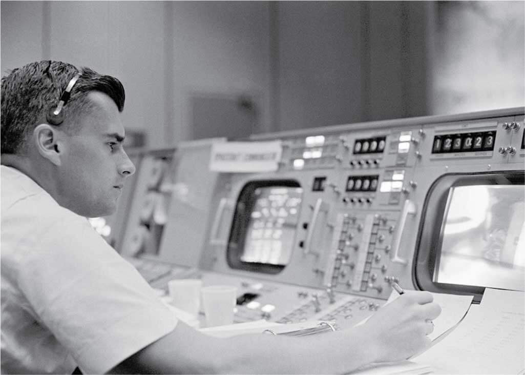 Astronaut Roger B. Chaffee is shown at console in the Mission Control Center, Houston, Texas during the Gemini-Titan 3 flight.