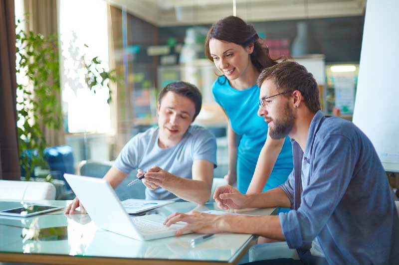 Three people in an office meeting