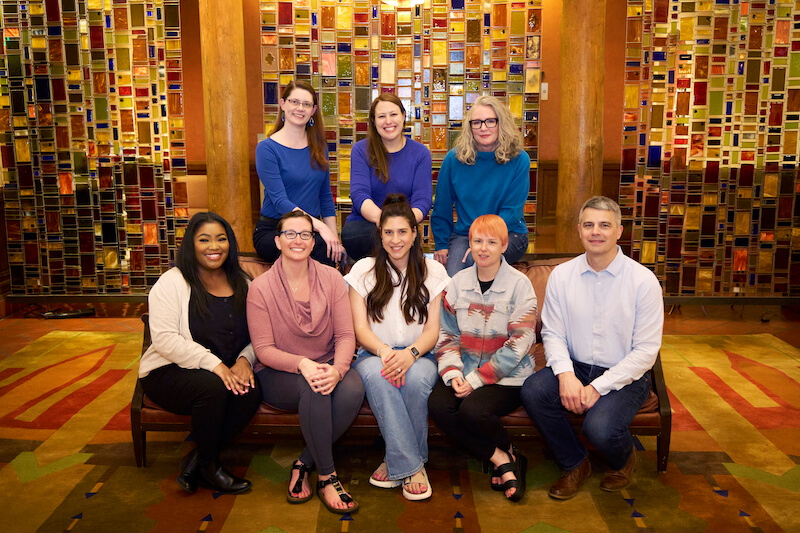 Front Row: Mikia Franklin, Associate Project Mgr.; Sierra Vejvoda, Project Mgr.; Lauren Heidecke, Associate Project Mgr.; Adrienne Paraczky, Project Mgr.; Patrick O'Rourke, VP; Back Row: Gillian Gentry, VP; Rachel Anschicks, Associate Project Mgr.; Josie Graham, Senior Project Mgr