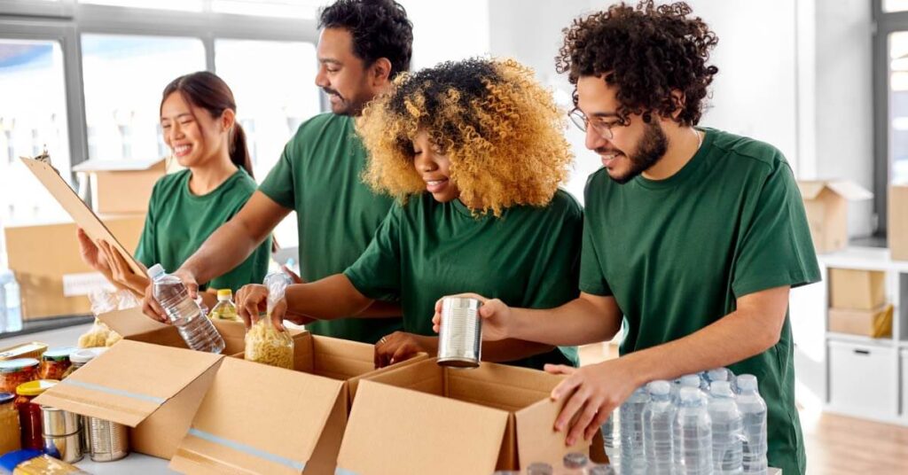 Volunteers helping pack food items for charity